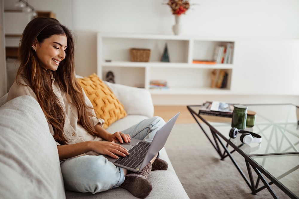 Ragazza con notebook sul divano