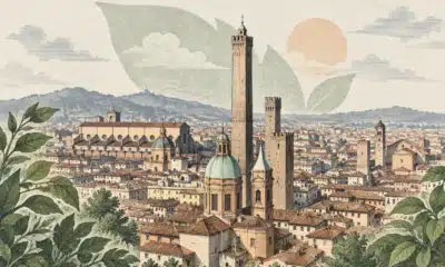 Illustrazione del profilo urbano di Bologna con le Due Torri e i tetti del centro storico.