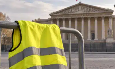 La facciata dell’Assemblea nazionale francese accanto a un gilet giallo